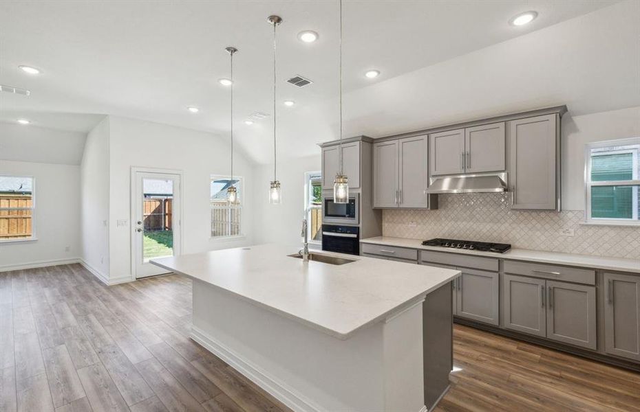 Bright kitchen with oversized island *real home pictured