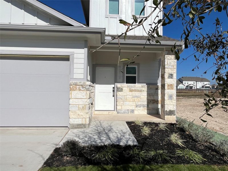 This is an exterior photo of another home that is the same floorplan/exterior colors and end townhome as 8522 Wellspring Loop