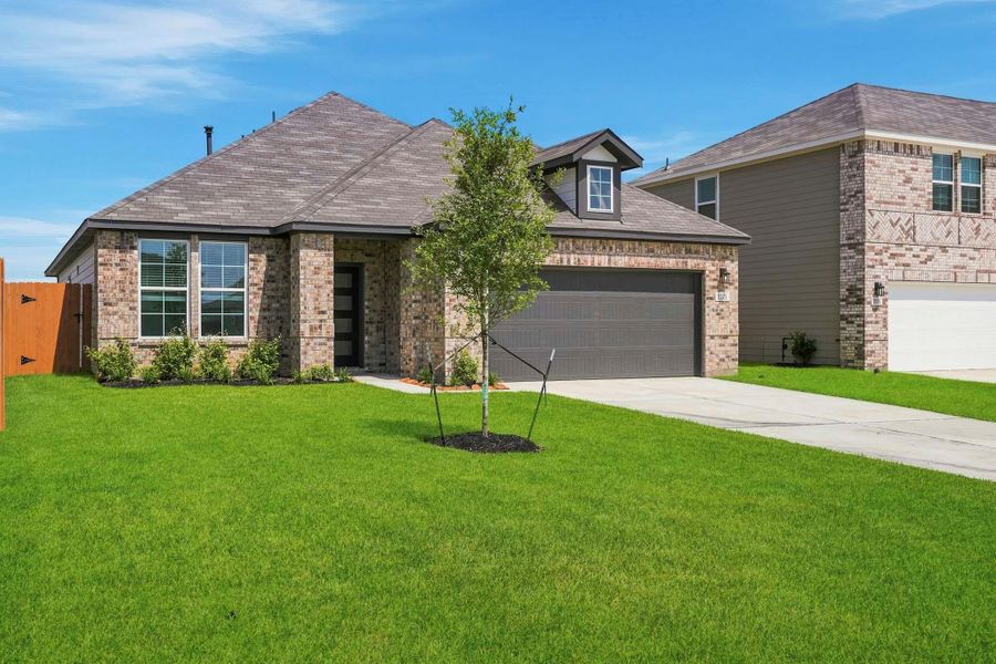Front exterior of a new home in Mirabella, Brookshire, TX, highlighting curb appeal (Image 2).