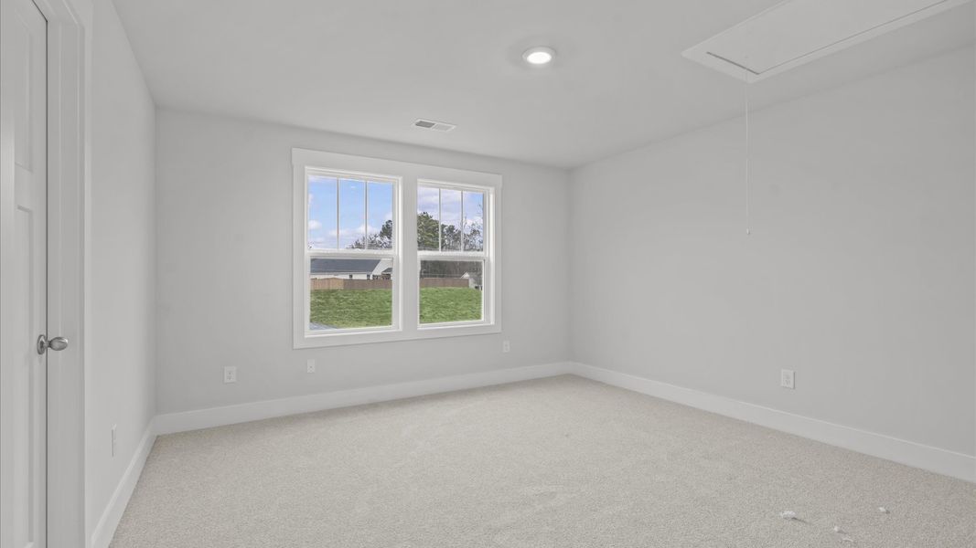 First-class bedroom with generous proportions, a walk-in closet, and beautiful natural light through large windows