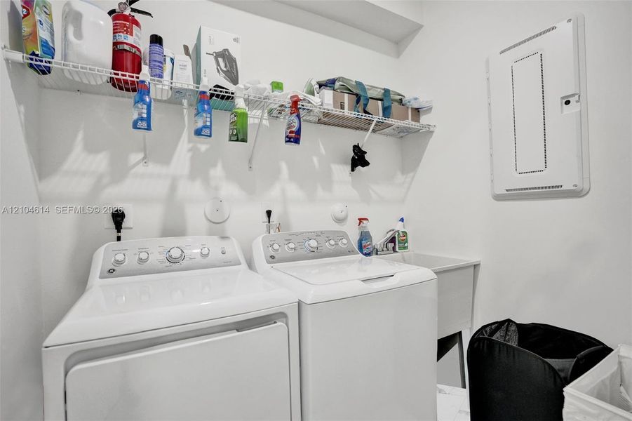 Utility room featuring a laundry sink