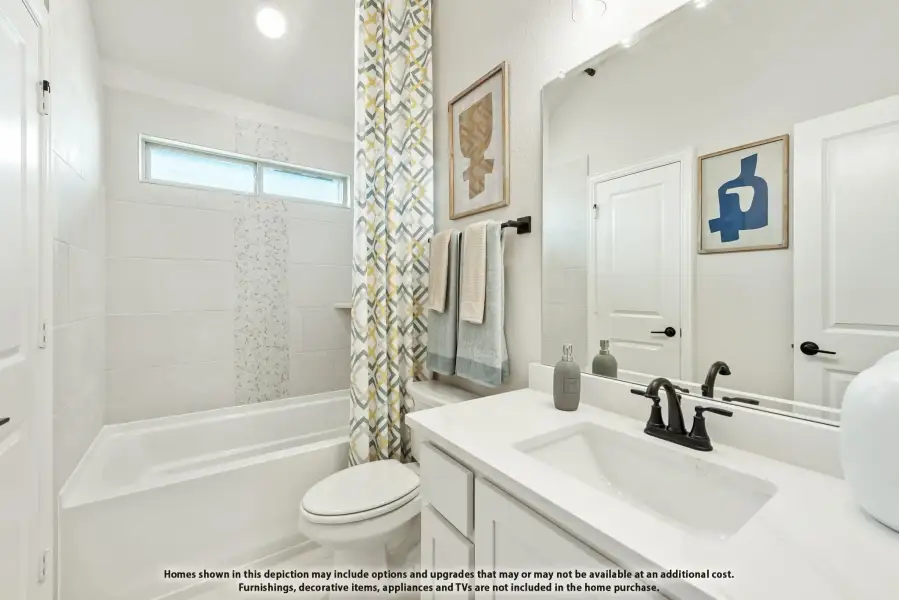 Bathroom with white vanity, tub-shower combo with patterned curtain, and large mirror Bathroom with white vanity, tub-shower combo with patterned curtain, and large mirror