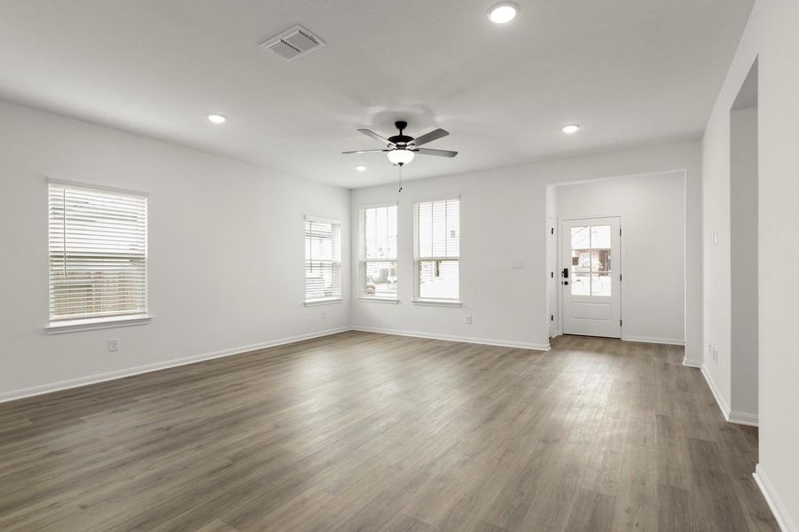 Unfurnished living room with a ceiling fan, dark wood-style flooring, and recessed lighting