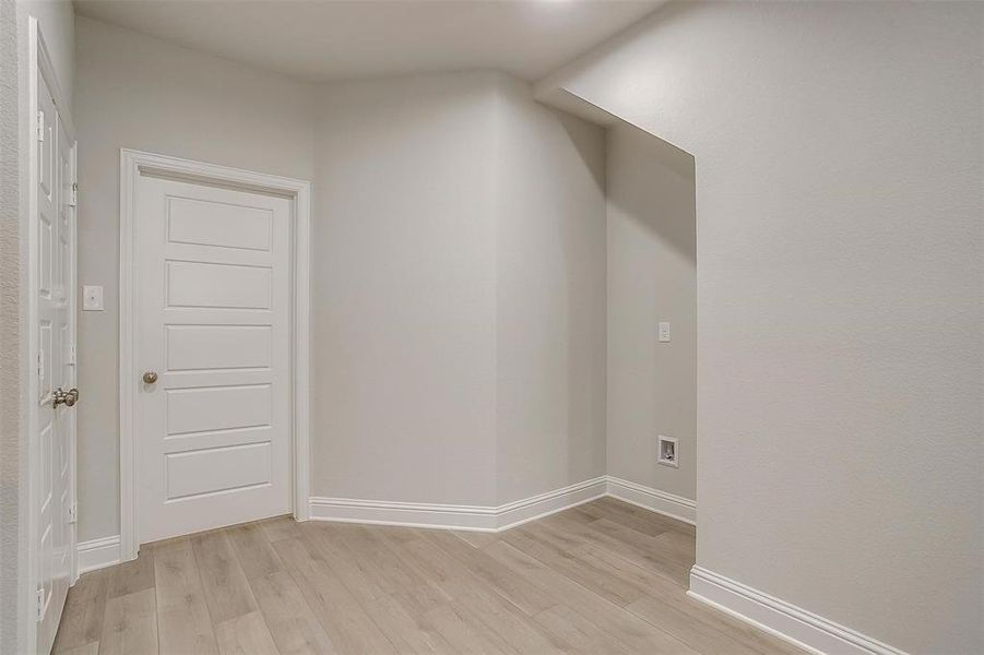 Bonus room featuring light wood-style floors and baseboards Bonus room featuring light wood-style floors and baseboards