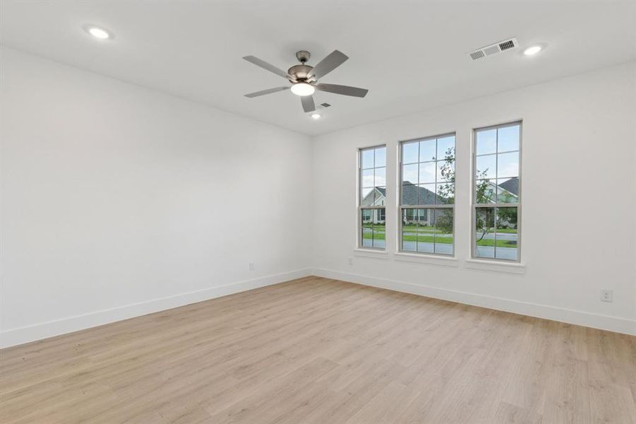 Spare room featuring light wood-style flooring, a ceiling fan, and recessed lighting Spare room featuring light wood-style flooring, a ceiling fan, and recessed lighting