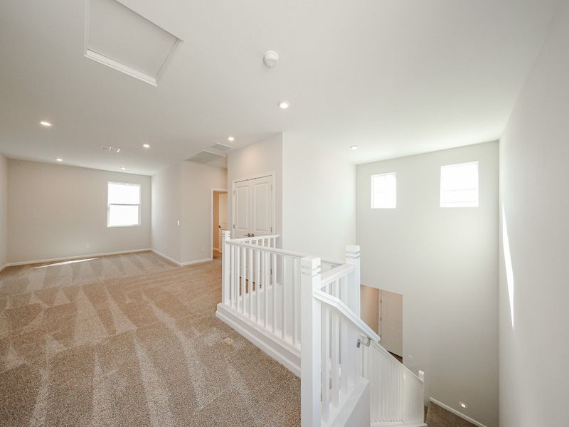 A room with white railings and a white staircase. A room with white railings and a white staircase.
