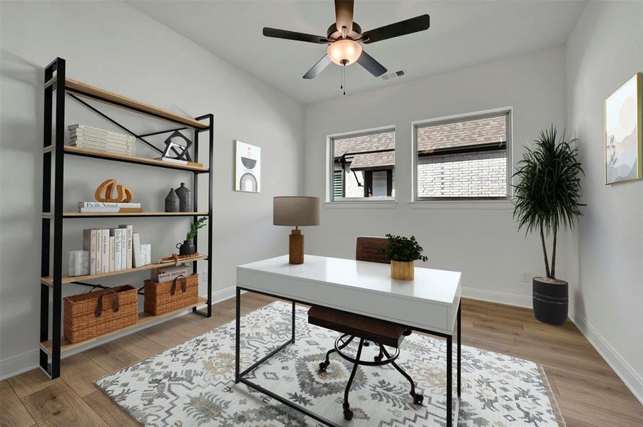 Home office featuring light wood-type flooring and ceiling fan