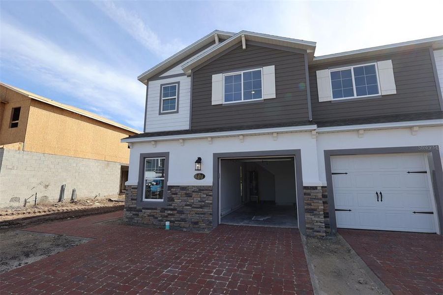 Front exterior of a new home in Tyson Ranch, Orlando, FL, highlighting curb appeal (Image 1).