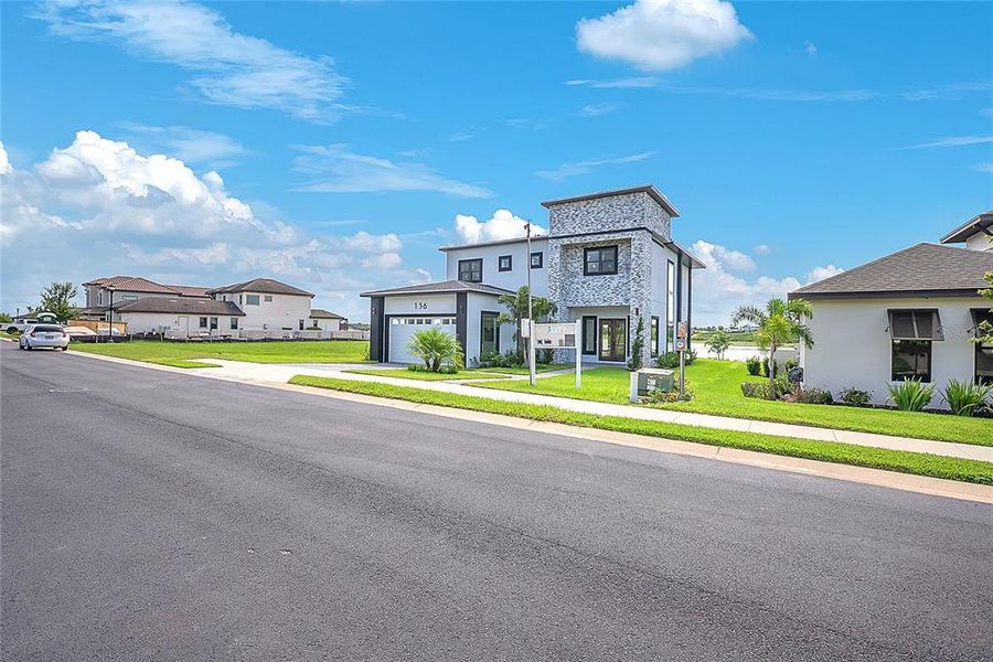 Front exterior of a new home in , Lake Alfred, FL, highlighting curb appeal (Image 27).