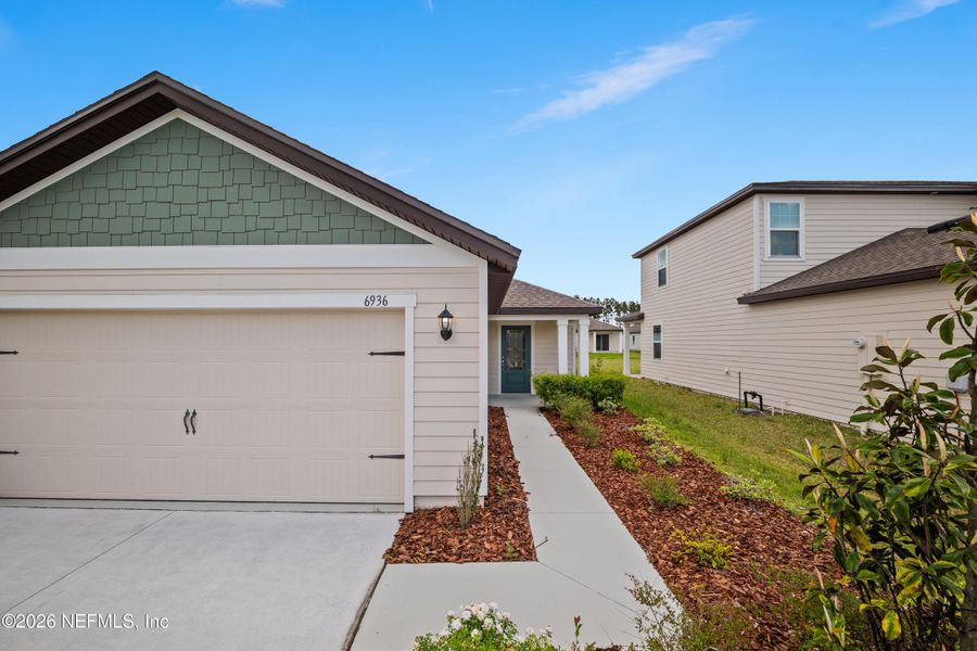 Front exterior of a new home in Westport Landing, Jacksonville, FL, highlighting curb appeal (Image 22).