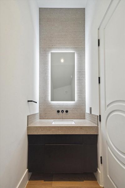 A refined first floor powder room offers an intimate and sophisticated space for guests
