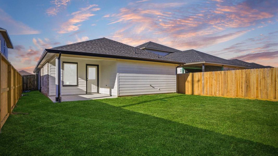 Large fenced-in backyard with a covered patio, perfect for outdoor entertaining.