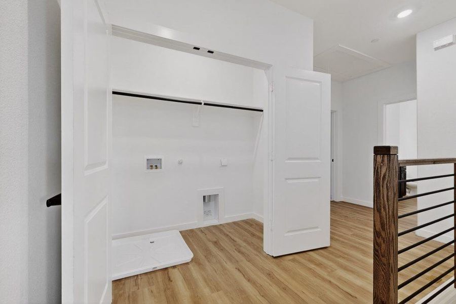 Laundry room with hookup for a gas dryer, light wood-type flooring, hookup for a washing machine, and recessed lighting Laundry room with hookup for a gas dryer, light wood-type flooring, hookup for a washing machine, and recessed lighting