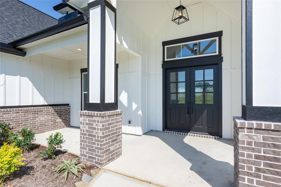 Welcoming front porch with elegant double doors.