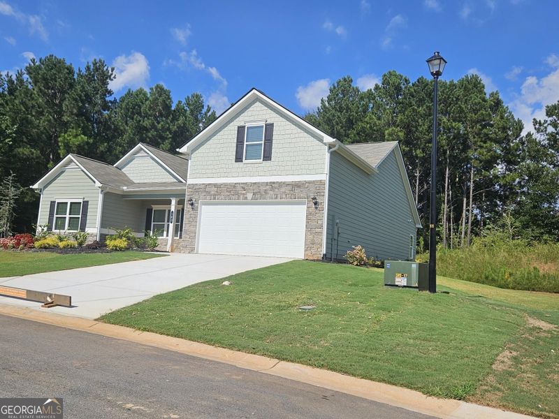 Front exterior of a new home in Maddox Station, Eatonton, GA, highlighting curb appeal (Image 22). Front exterior of a new home in Maddox Station, Eatonton, GA, highlighting curb appeal (Image 22).