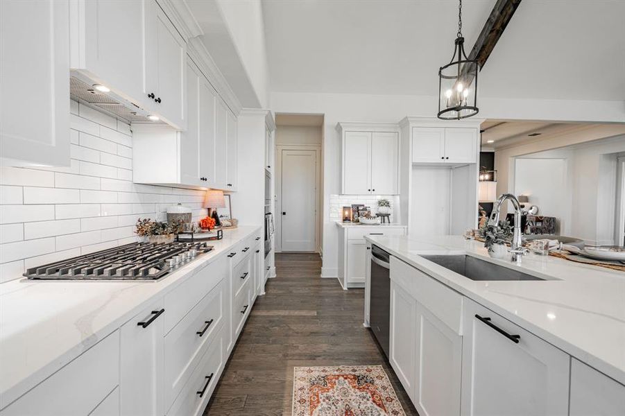 Kitchen featuring light quartz countertops, dark hardwood / wood-style floors, and white cabinets