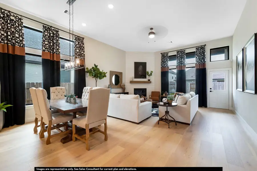 Dining area with light wood finished floors, a large fireplace, and recessed lighting Dining area with light wood finished floors, a large fireplace, and recessed lighting
