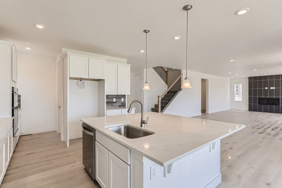 Kitchen island in Cornell II plan at The Outlook at Southshore by Century Communities