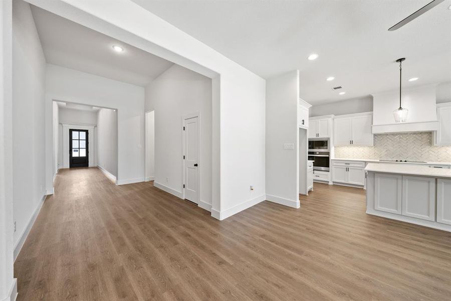 Unfurnished living room with light wood-style floors, recessed lighting, and a ceiling fan