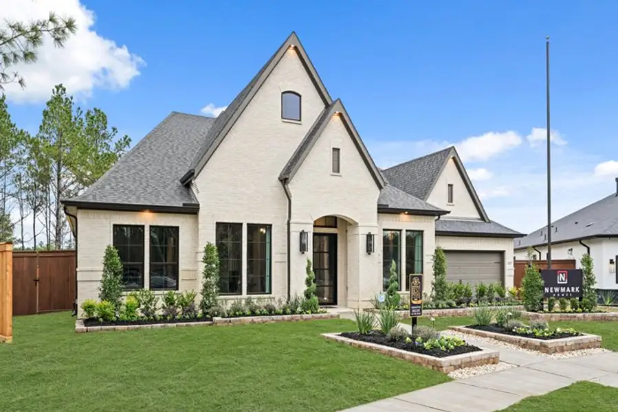 Front exterior of a new home in Wildtree 70', Montgomery, TX, highlighting curb appeal (Image 2). Front exterior of a new home in Wildtree 70', Montgomery, TX, highlighting curb appeal (Image 2).