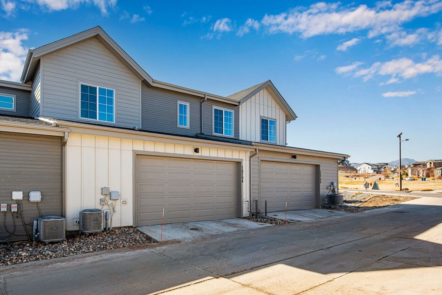 Front exterior of a new home in Candelas Townhomes, Arvada, CO, highlighting curb appeal (Image 32).
