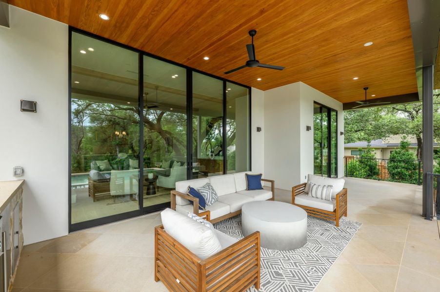 An inviting outdoor oasis with ample seating and a warm wood-paneled ceiling. An inviting outdoor oasis with ample seating and a warm wood-paneled ceiling.