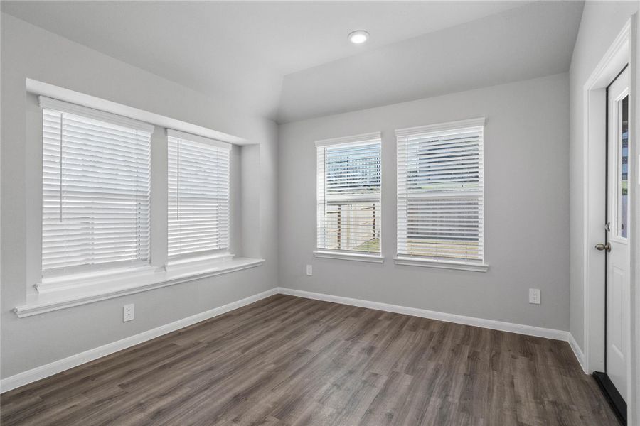 Enjoy meals in this sun-drenched space, featuring durable luxury vinyl flooring, large windows (fitted with blinds), window seat for added seating, and recessed lighting. An access door to the back covered patio is conveniently located for ease of indoor to outdoor living. Enjoy meals in this sun-drenched space, featuring durable luxury vinyl flooring, large windows (fitted with blinds), window seat for added seating, and recessed lighting. An access door to the back covered patio is conveniently located for ease of indoor to outdoor living.