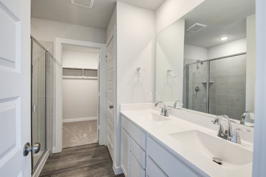 A bathroom with a glass shower. A bathroom with a glass shower.