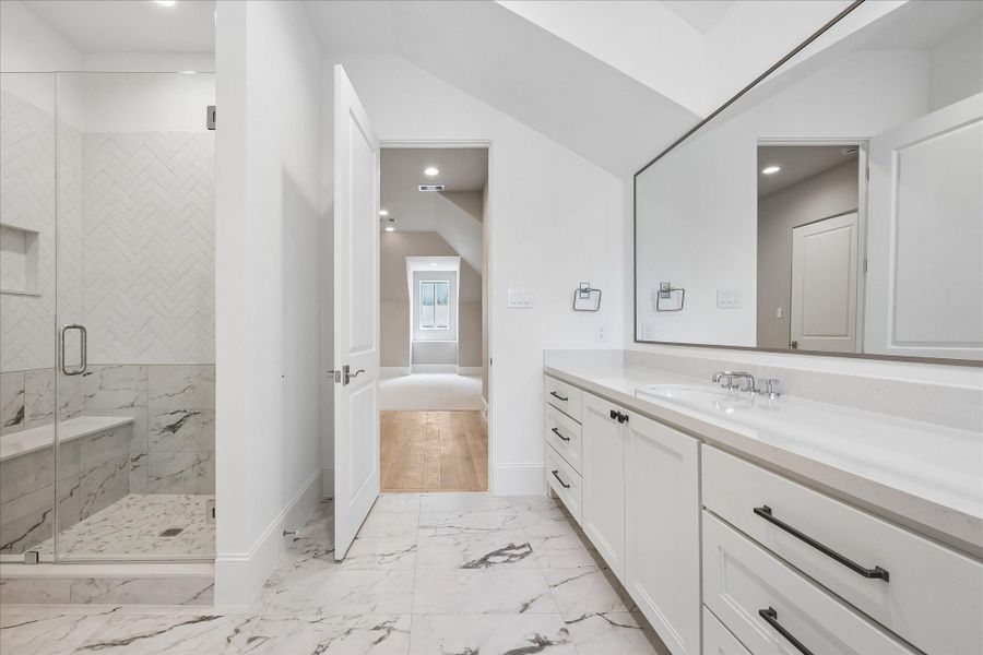 Bathroom on the third floor with large counter space, glass-encased shower, and walk-in closet.