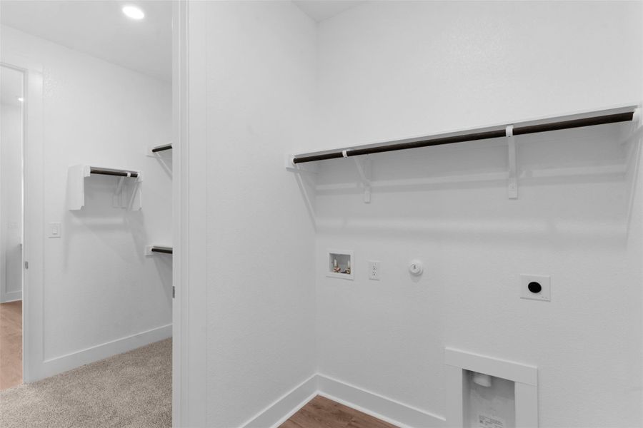 Functional laundry space with integrated shelving and convenient hookups for appliances. Functional laundry space with integrated shelving and convenient hookups for appliances.