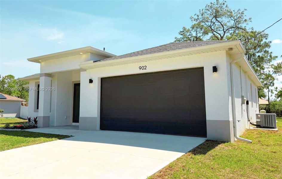 Front exterior of a new home in , Lehigh Acres, FL, highlighting curb appeal (Image 1). Front exterior of a new home in , Lehigh Acres, FL, highlighting curb appeal (Image 1).