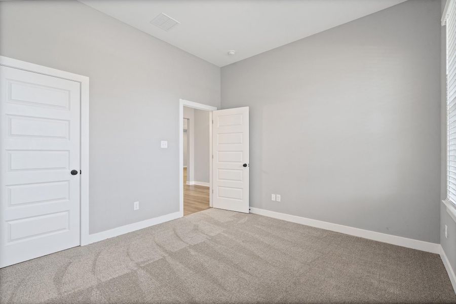 Neutral gray walls with white trim and multi-panel doors Neutral gray walls with white trim and multi-panel doors