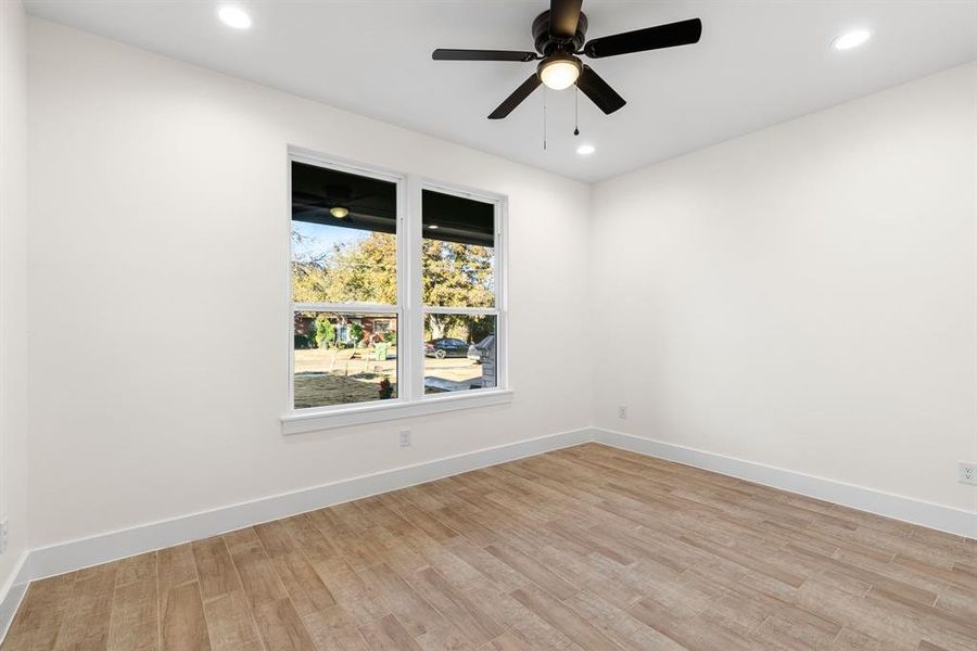 Empty room featuring light hardwood / wood-style flooring and ceiling fan