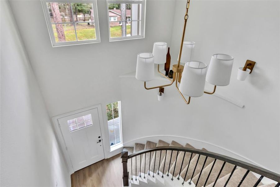 Charming balcony with views of a stunning spiral staircase.