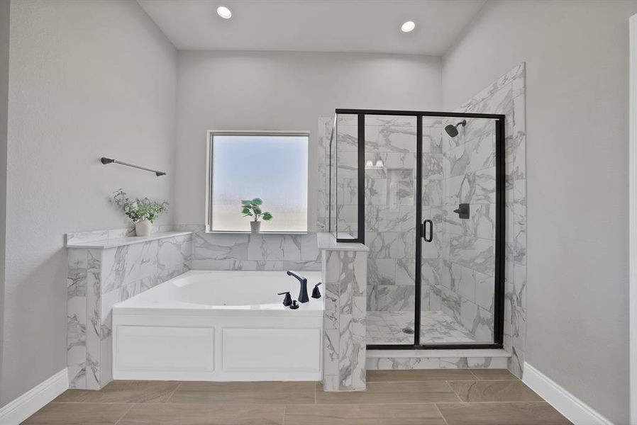 Full bath featuring a bath, a marble finish shower, baseboards, and recessed lighting Full bath featuring a bath, a marble finish shower, baseboards, and recessed lighting