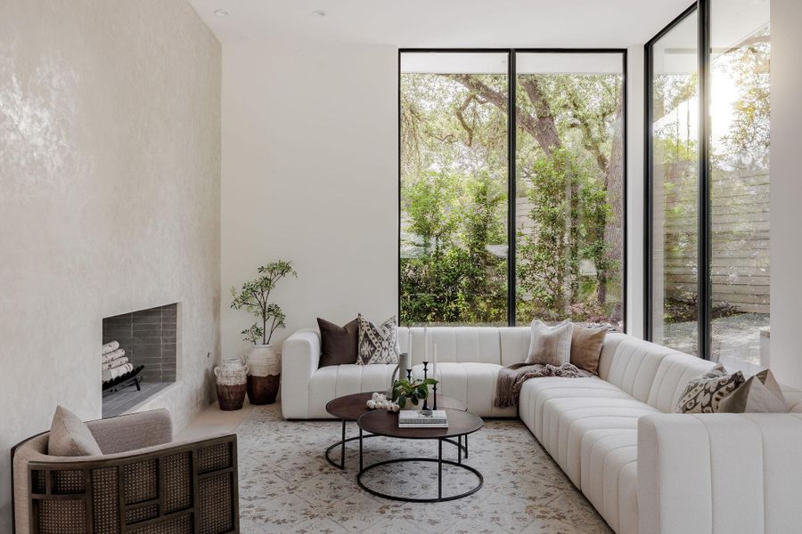 Living room with plenty of natural light and floor to ceiling windows Living room with plenty of natural light and floor to ceiling windows