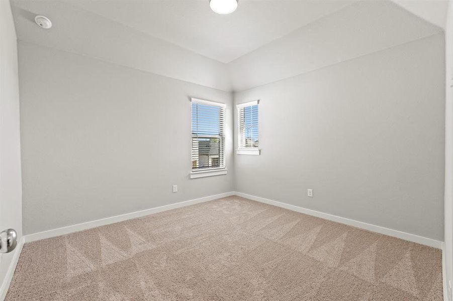 Empty room featuring light colored carpet
