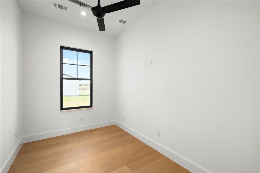 Unfurnished room with baseboards, light wood-style flooring, a ceiling fan, and recessed lighting