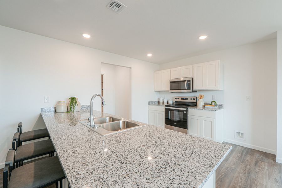 A kitchen with marble counters.