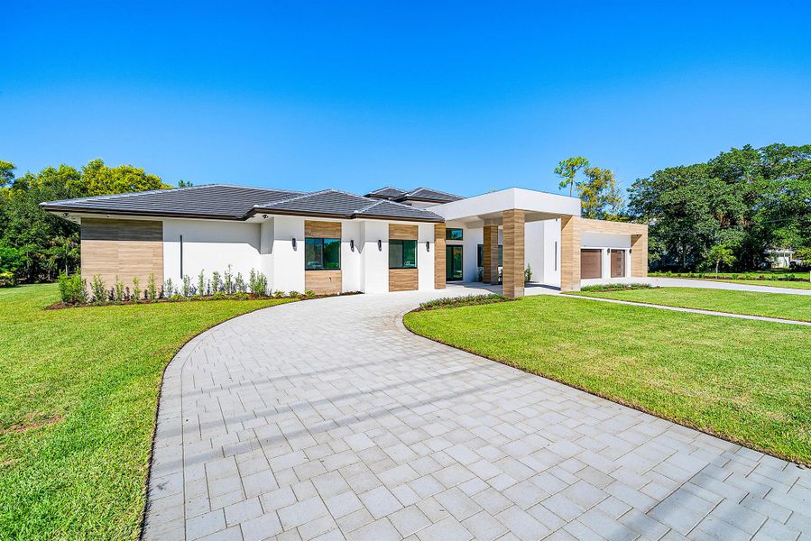 Front exterior of a new home in , Wellington, FL, highlighting curb appeal (Image 25).