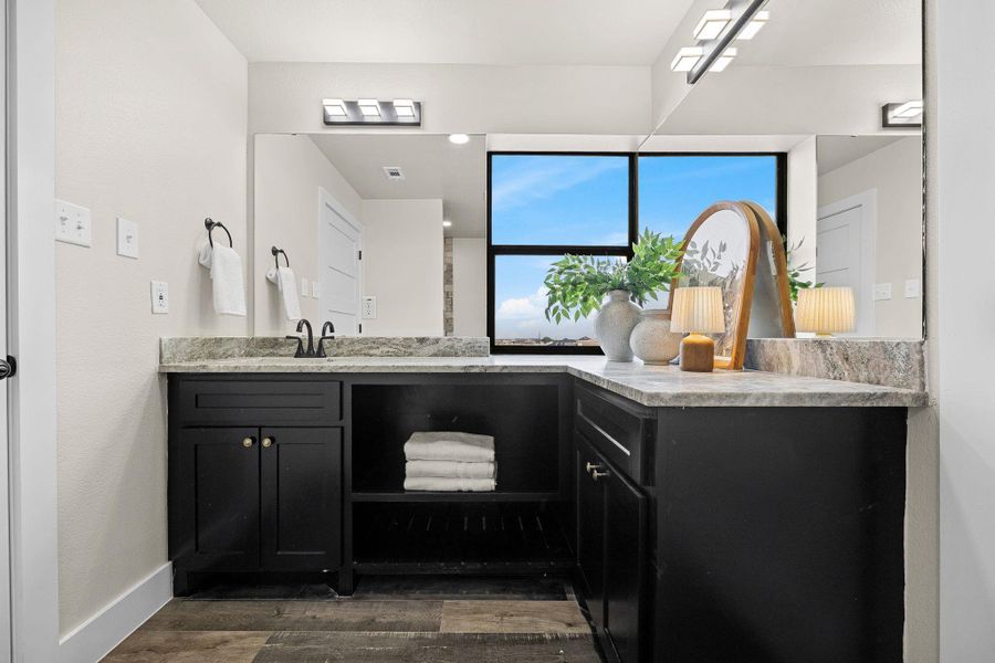 Bathroom featuring vanity and dark wood-type flooring Bathroom featuring vanity and dark wood-type flooring