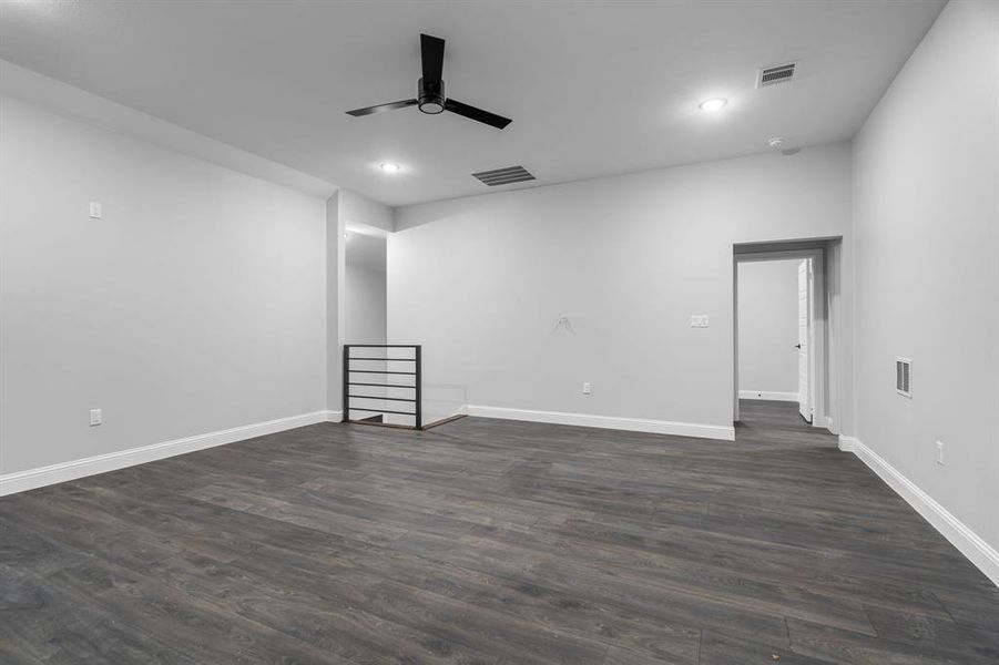 Spare room with ceiling fan and dark hardwood / wood-style floors