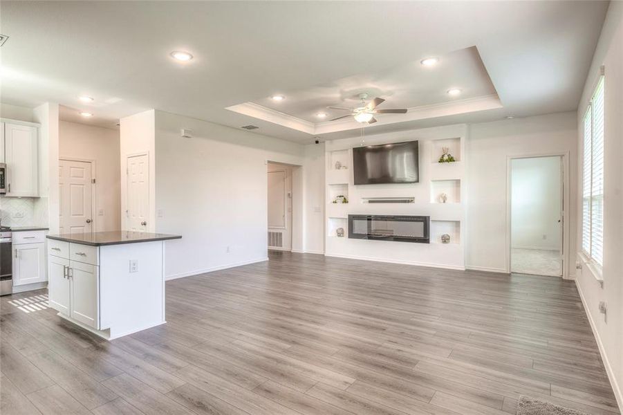 Kitchen featuring white cabinets, a center island, recessed lighting, a ceiling fan, and open floor plan Kitchen featuring white cabinets, a center island, recessed lighting, a ceiling fan, and open floor plan