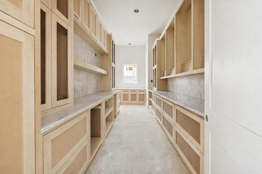 A beautifully appointed butlers pantry designed to keep the main kitchen pristine while offering exceptional storage and prep space. Custom cabinetry lines both sides, creating a streamlined and efficient workflow. This hidden extension of the kitchen adds a layer of luxury that homeowners truly appreciate once they experience it. A beautifully appointed butlers pantry designed to keep the main kitchen pristine while offering exceptional storage and prep space. Custom cabinetry lines both sides, creating a streamlined and efficient workflow. This hidden extension of the kitchen adds a layer of luxury that homeowners truly appreciate once they experience it.