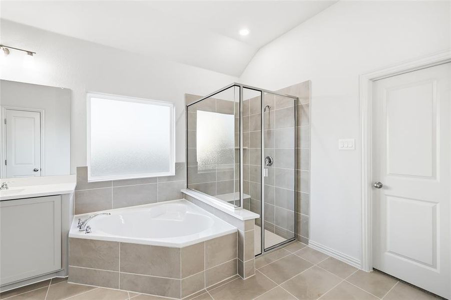Bathroom with a bath, lofted ceiling, a stall shower, light tile patterned floors, and recessed lighting