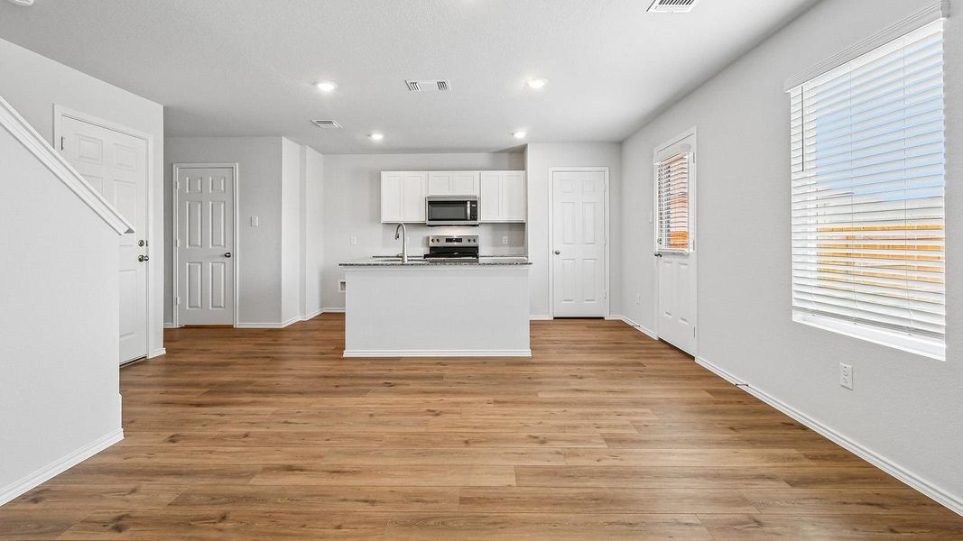 An inviting open-concept layout connects the kitchen to a spacious living area, ideal for modern living.