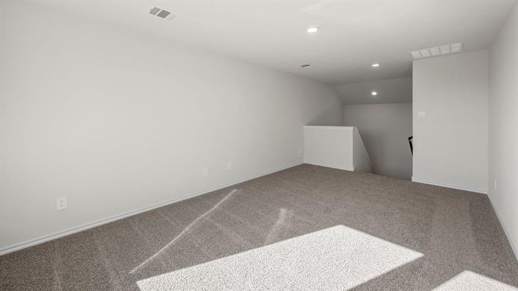 Spare room with carpet, lofted ceiling, and recessed lighting