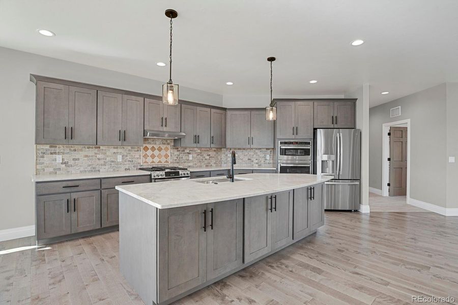Large kitchen island.  Door on the right is entry to laundry room