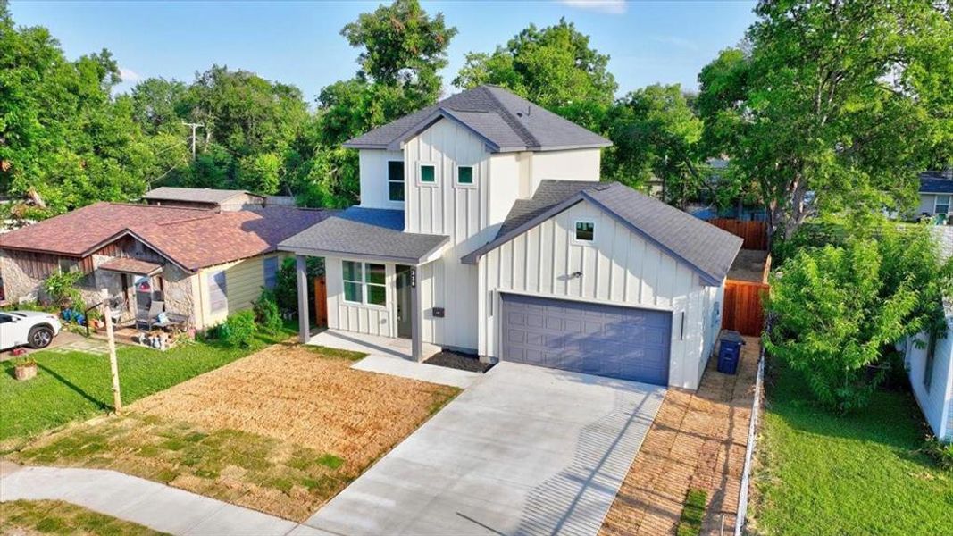 Modern two-story residence with vertical siding and a dark gray shingle roof Modern two-story residence with vertical siding and a dark gray shingle roof