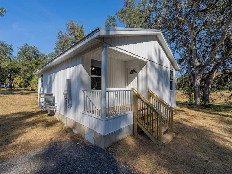 Exterior details and patio area of a home in , Fort McCoy (Image 14).